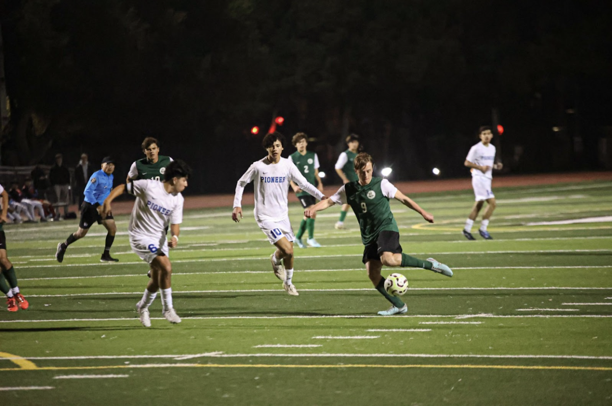 Viking senior Finnegan Schoebel shoots through two defenders in a draw against the Pioneer Mustangs Friday night at home. According to Lodino, the team will improve as they build camaraderie and chemistry with one another. 

“We had a long talk after the game about how well they [the players] know each other, and what they know about each other,” Lodino said. “It's a new group. Now that our next game isn’t until Jan. 3 we can use the break to build trust and feel more comfortable.” 

