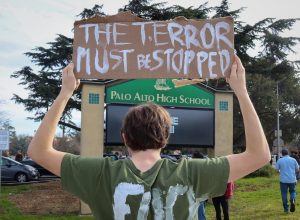 Senior Duncan Sego held a sign reading "The Terror Must be Stopped" during a student walkout protesting Immigration and Customs Enforcement in front of Palo Alto High School today at noon. According to Sego, people need to take a stand against ICE. "This [ICE] isn’t what the people want, this isn’t what we want and it’s destroying communities," Sego said. "People need to rally against them." 