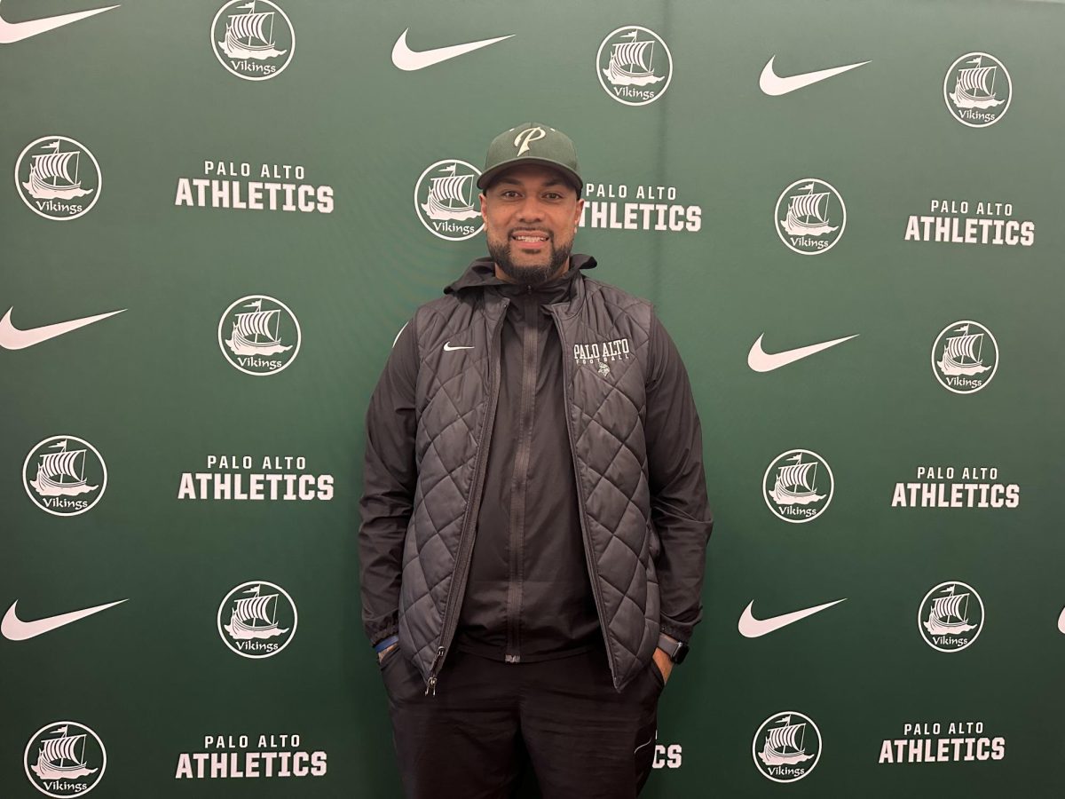 Football head coach Edward Tonga poses inside the athletic director’s office today at Palo Alto High School after being named the program’s new head coach. According to Tonga, balancing athletes’ responsibilities beyond athletics limited preparation, making great involvement ahead of competition an important factor in improving results. “At the time [football season], a lot of the players were involved in other sports, involved in school and also work,” Tonga said. “On top of that, it’s time management. This year, if I am able to do a lot with them during the off-season and be more present, it will definitely help shape the football season.”