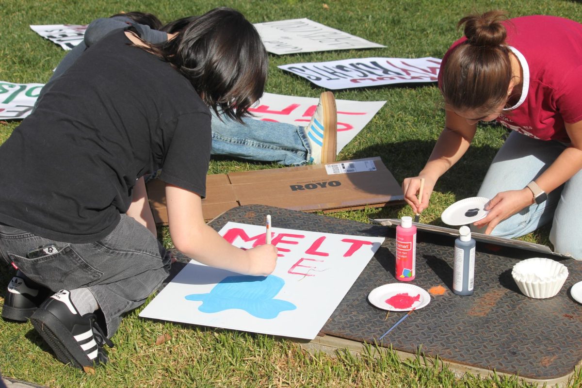 Students make protest signs at the Quad at Palo Alto High School during Thursday’s lunch in preparation for a Friday walkout to protest against Immigration and Customs Enforcement actions. According to participant and sign-maker Maya Cheng, the walkout is a great opportunity for students to speak up. “It's really cool to see how a bunch of people are coming together to really use their voice,” Cheng said.