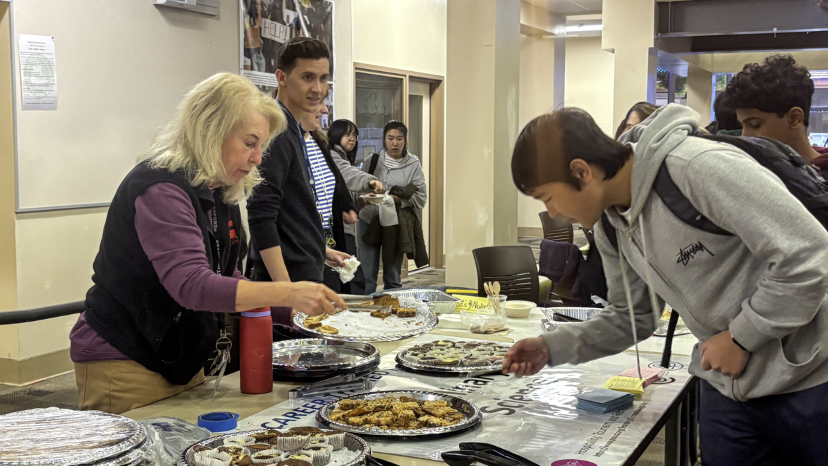 Cindy Peters, culinary science teacher at Gunn High School, distributes student-made pastries this afternoon at the Career Tech Education showcase in the Palo Alto High School Media Arts Center. According to Peters, her graduated students often attend culinary school and pursue a professional culinary career. “I help a lot of students with continuing their culinary journey," Peters said. "Two Gunn [High School] alumni opened a restaurant in Town and Country — Hatched." 
