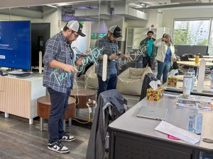 Recreation leader Bradley Smith sets up a neon sign for the City of Palo Alto's new teen center during its soft opening on Feb. 19 at 429 Bryant St. According to Smith, The Rise is still working on marketing the center to reach more students. “There's a sign outside the door, but it’s a little bit hard to find the building, so we're going to get more signage, and we'll be going around the high schools too, tabling and promoting it in the upcoming weeks,” Smith said. “Hopefully, that gets the word out as soon as we can."