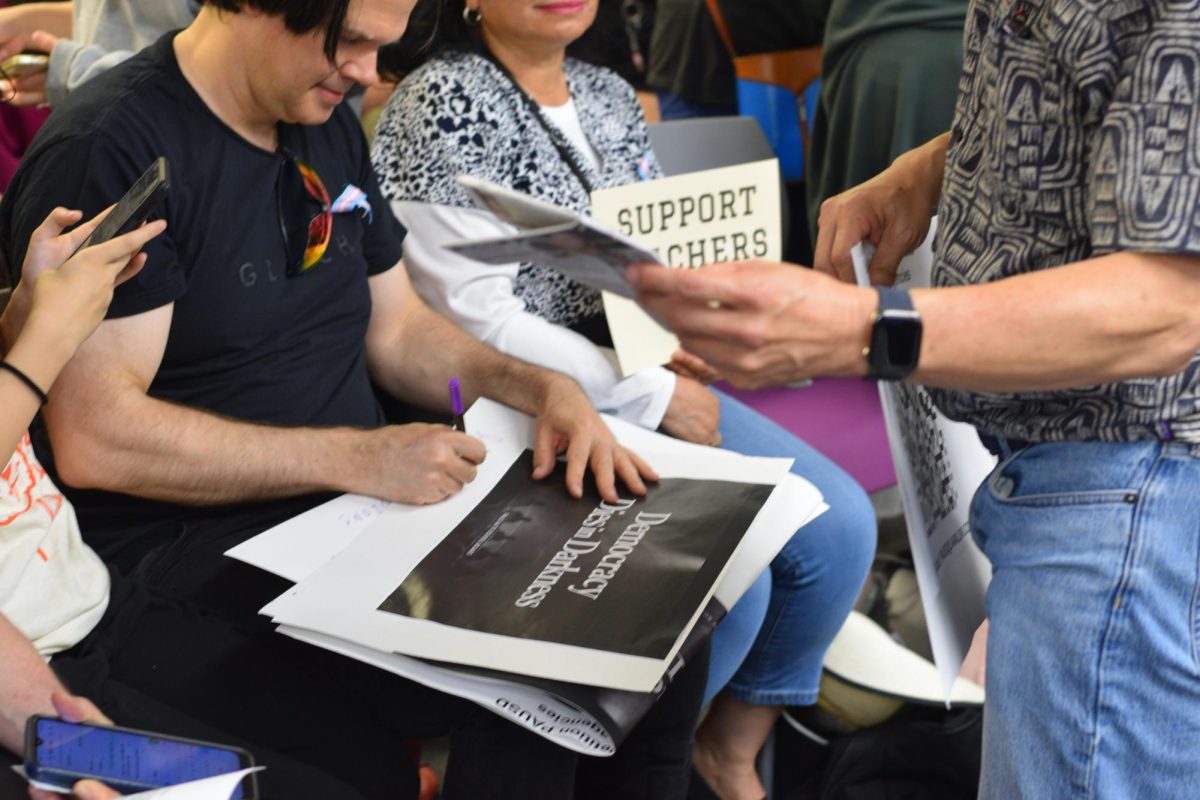 Palo Alto Educators Association members make signs during Tuesday's board meeting to advocate for having their voice heard. Palo Alto High School english teacher Erin Angell said she hopes the upcoming rally draws a crowd comparable to recent district board meetings. “I hope we have as many teachers, students, and families that would like to participate to participate, it's open to anyone, “Angell said. “I would love to see a similar number of people who attended the board meeting last night to show up to the rally.”
