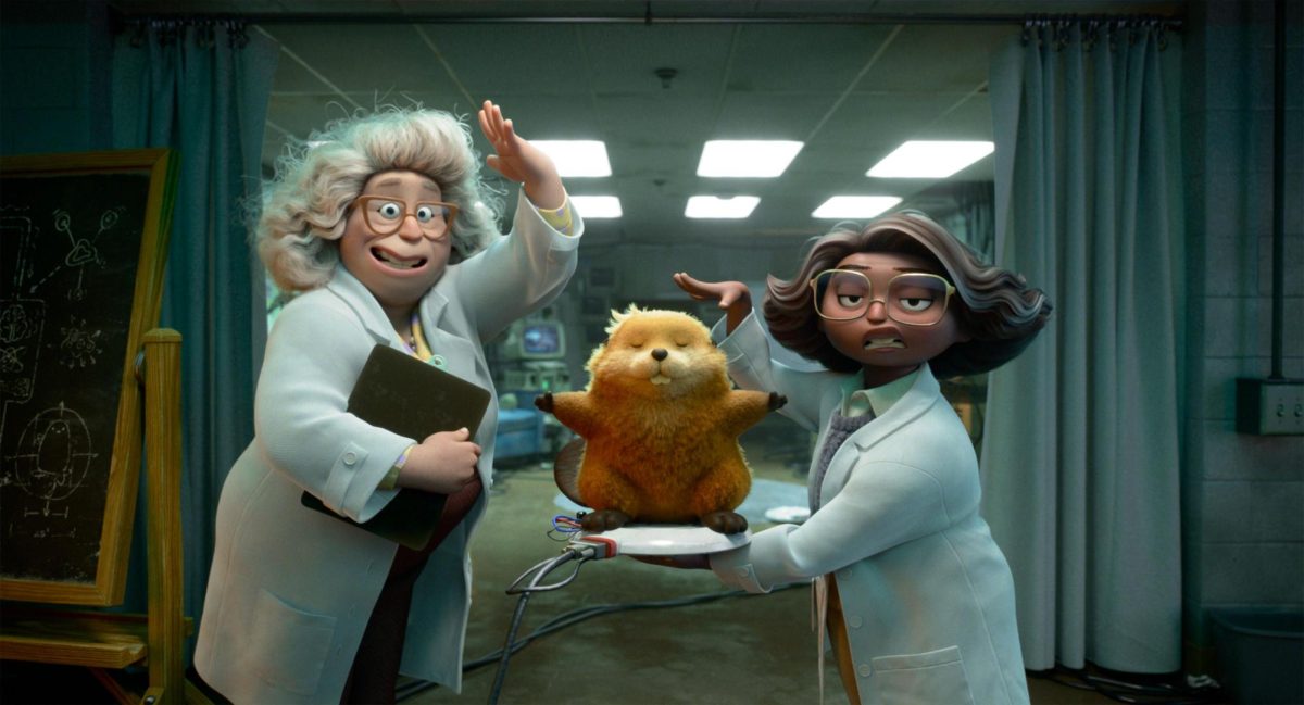 Dr. Sam (Kathy Najimy) and her lab assistant Nisha (Aparna Nancherla) present their latest prototype of a robotic beaver to Mabel Tanaka (Piper Curda) in "Hoppers" (Pixar, 2026).