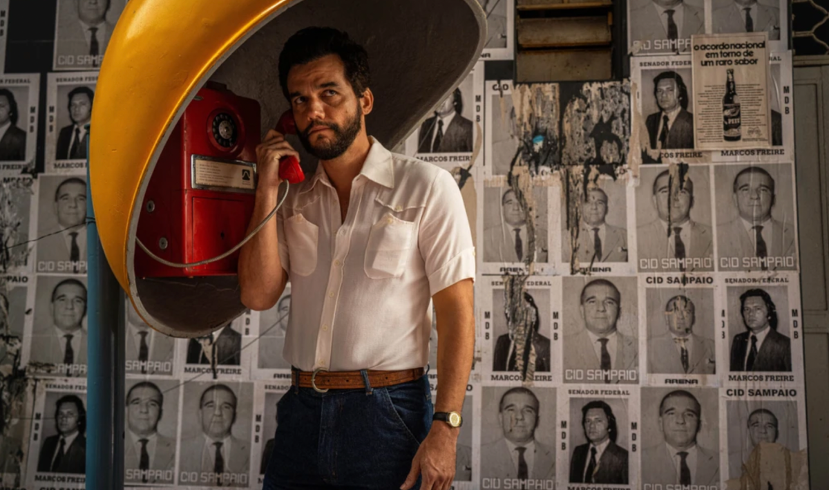 Armando Solimões (Wagner Moura) makes a call on a payphone. Throughout "The Secret Agent," known in the orgianal Portuguese as “O Agente Secreto,” Armando receives updates about being followed through these calls, showing the intense paranoia under Brazil's military dictatorship in 1977. 