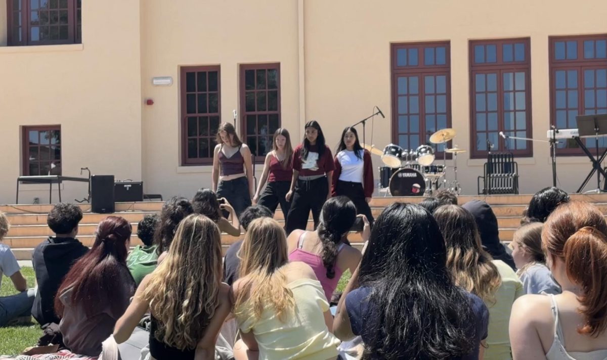 Members of Palo Alto High School's K-pop Dance Club, PALYCE, stand in the starting formation of their Quadchella performance. According to Thais Gonzalez, a member in the dance performance, the group practiced frequently to bring their best moves. "We had early morning, lunch break, weekends and after-school sessions — over 10 practices in total," Gonzalez said. "That consistency and commitment to each other is what really brought the performance together."