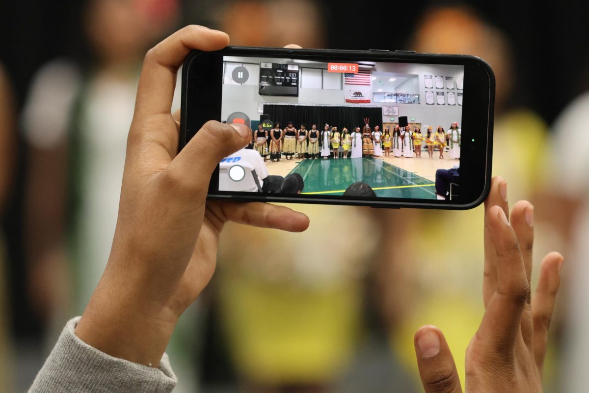 A student records the Paly Poly Club performing at Paly's second ever cultural assembly. During the assembly, students sing, dance or recite poems to represent their culture. According to sophomore and performer Liani Ragade, the various performances during last year's cultural assembly was what encouraged her to perform. "Watching it last year, I just thought it was amazing to see everybody singing, dancing and just all these wonderful performances," Ragade said. "I thought it'd be fun to try it myself as well."