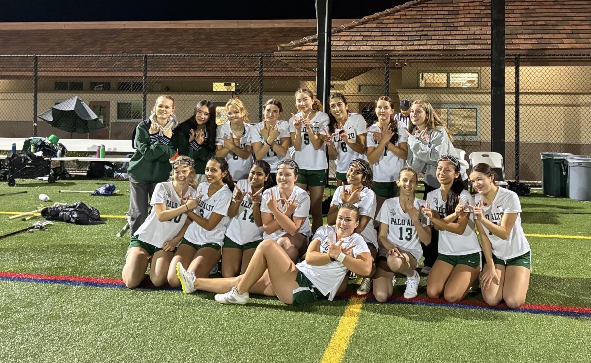 Viking girls' lacrosse huddles up for a group photo after defeating Gunn on April 22nd at Palo Alto High School. According to senior Meera Singh, winning the Santa Clara Valley Athletic League (SCVAL) title gave the Vikings confidence moving forward. "I realized we could win CCS when we won the league," Singh said. "Until then, I'm just used to our team being so bad, I never really thought of [winning a section championship] for us."
