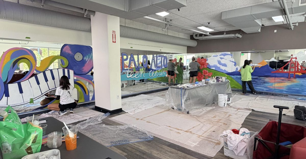 Teen volunteers paint a mural on May 10 on the mirror in the Bryant Street Community Center. According to Teen Arts Council co-president Avni Lochan, painting this mural helped her get in touch with her artistic skills. "I don't paint, draw or do a lot of fine arts very often," said Lochan, a Palo Alto High School junior. "Painting in this kind of atmosphere and at this event has been very relaxing and inviting for me because it's allowed me to mess up. It's allowed me to kind of go with what I feel and not always follow exactly what is designed, and it's led me to explore my artistic side."