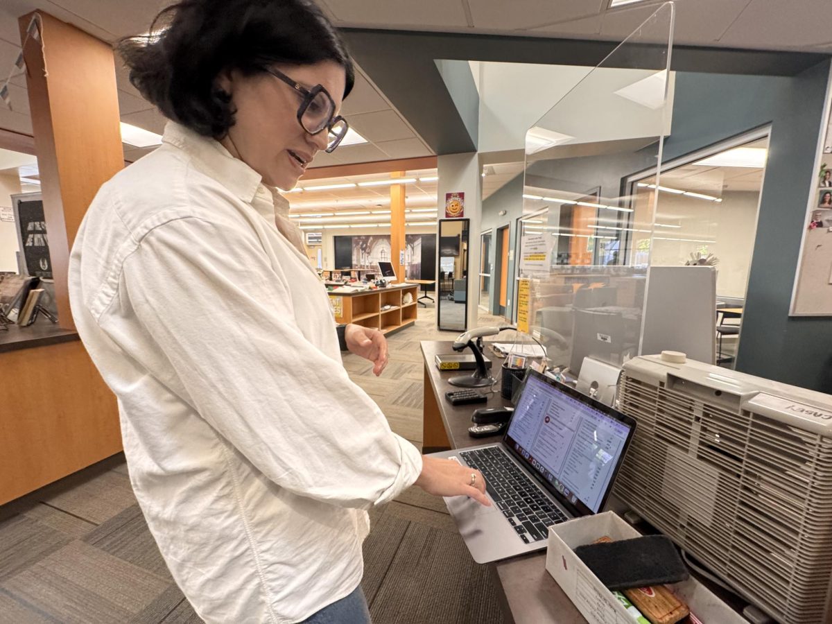 Palo Alto High School Librarian Sima Thomas uses her computer to look at the number of overdue and missing books. According to Thomas, one of the incentives the library formerly had used  — but no longer allowed — was not allowing students to get their yearbooks until they returned all their overdue books. "It was at the end of the year, and students couldn't get their yearbooks until they'd cleared not just their library books, but also textbooks, etc." Thomas said. "It worked really well because everyone wanted their yearbooks, so there was this big scramble."