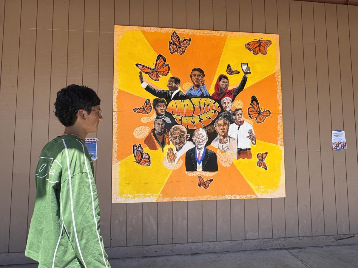 Senior Shalin Dwivedi walks past a now-removed mural, gifted by the Latinos Unidos, depicting a variety of influential social activists, including César Chávez at the top that Palo Alto High School administration took down. According to visual arts teacher Tracey Atkinson, making a new mural would be a big time commitment for students interested. "People think it [a mural] can be done in like 5 hours, but really it's more like 100 hours," Atkinson said. "Sometimes students get very excited about an idea, but then don't actually want to put the time in to make it happen because they're very busy and that's understandable."