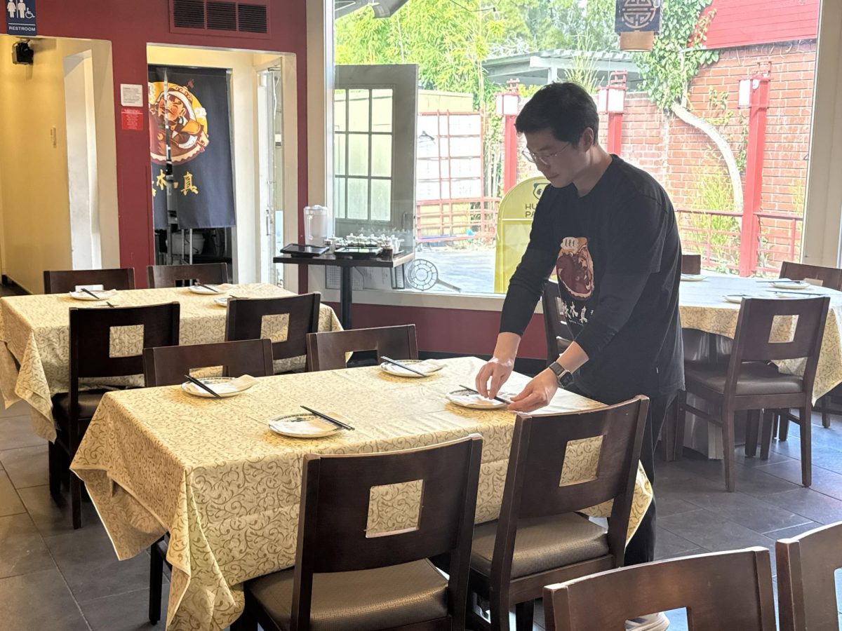 A waiter sets out new plates and chopsticks at a table on a Saturday at Tie Mu Zhen. According to restaurant owner and head chef Alex Wu, one of the hardest parts of preparing any dish with lamb is finding the right meat. "Here [in the Bay Area], we try to find meat similar to the ones back in Inner Mongolia," Wu said "America's lamb meat is both expensive and tastes very different, so we buy Australian lamb, which tastes more similar."