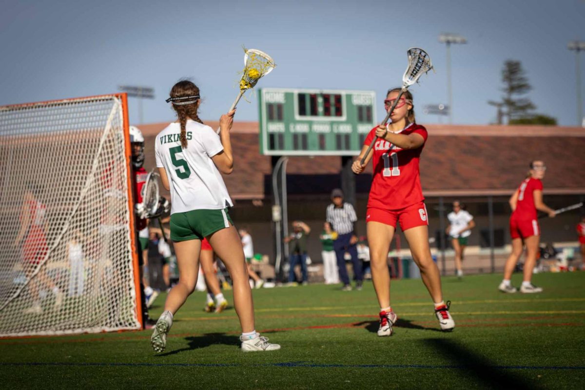 Viking freshman Hanna Karsner looks to pass the ball against the Carmel High School Padres on Tuesday at home. According to Viking head coach Kaitlin Chu, the Vikings excelled at draw control during the game. "There were a lot of great things," Vikings head Coach Kaitlin Chu said. "We had a 96% draw control, which means that we pretty much dominated on the draws. Obviously the score reflected that as well."