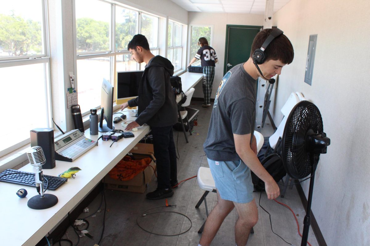 InFocus students set up the press box at Earl Hansen Stadium in preparation for the livestream they will be conducting during the Thursday graduation ceremony at Palo Alto High School. According to Rod Satterthwaite, the adviser for the broadcast journalism class, the livestream is a great way to open up the accessibility of the ceremony. “It provides the community benefit," Satterthwaite said. "It offers people who can't come because of disabilities or because they live far away the opportunity to watch their grandchild or child walk across the stage and be present for that moment.” 