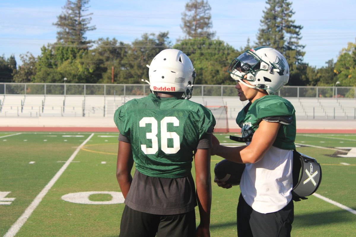 Senior quarterback and varsity football captain Justin Fung gives advice to junior running back Okiki Asogba Tuesday during practice in preparation for Thursdays’ game against Leigh High School at home. According to Fung, the team’s hard work at practice will eventually pay off. “We are going to keep working hard, keep our heads down and it’ll show eventually,” Fung said.