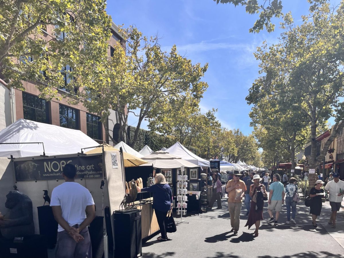 Community members browse the art vendors that lined University Avenue at the Palo Alto Festival of the Arts, on Aug 22-23. According to the CEO and President of the Palo Alto Chamber of Commerce Charlie Weidanz, the festival's atmosphere was calming for the community. “People enjoy it [the festival],” Weidanz said. “They’re relaxed. You can see they’re just strolling up and down the street or they’re sitting listening to the music.”