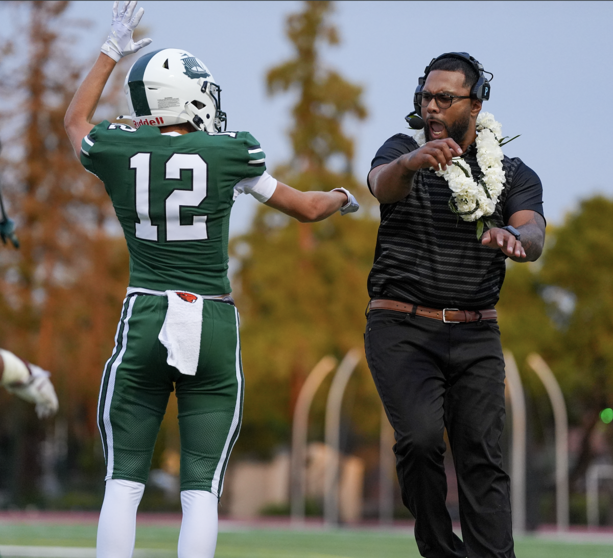 Palo Alto High School wide receiver Bronson Lindgren celebrates with head coach Edward Tonga after hauling in one of his three touchdowns Thursday night. According to Tonga, the Vikings' success was a byproduct of the team chemistry. “Everybody did their part," Tonga said. "They stepped up, just playing as a unit.”